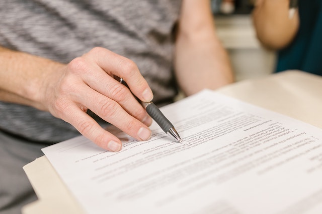 someone reading a contract with a pen